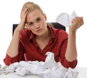 Frustrated woman crumpling paper